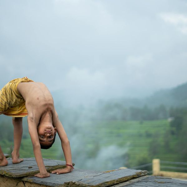 Person meditating peacefully outdoors with a serene natural background.